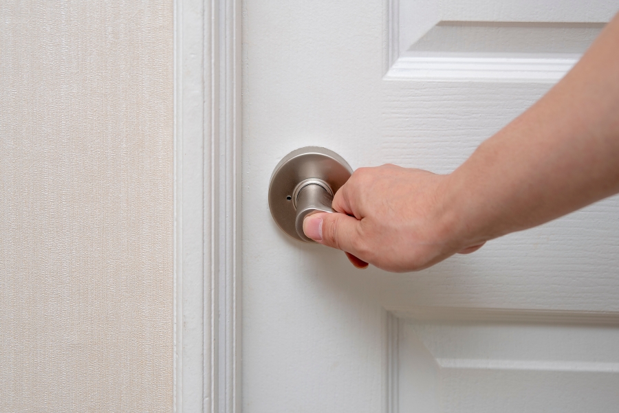 Photo of a person closing a door