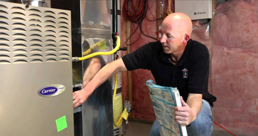 Photo of a person changing the furnace filter