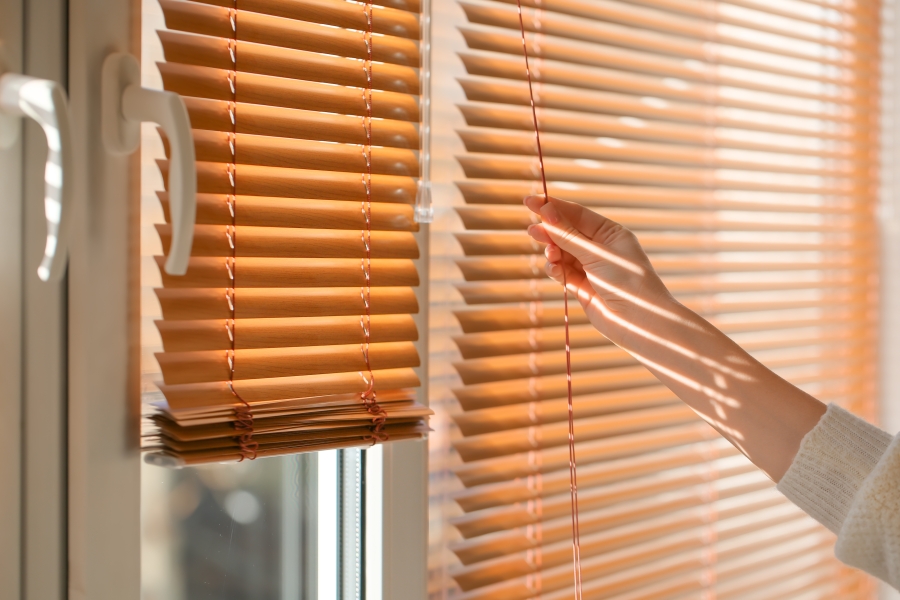 Photo of person shutting blinds