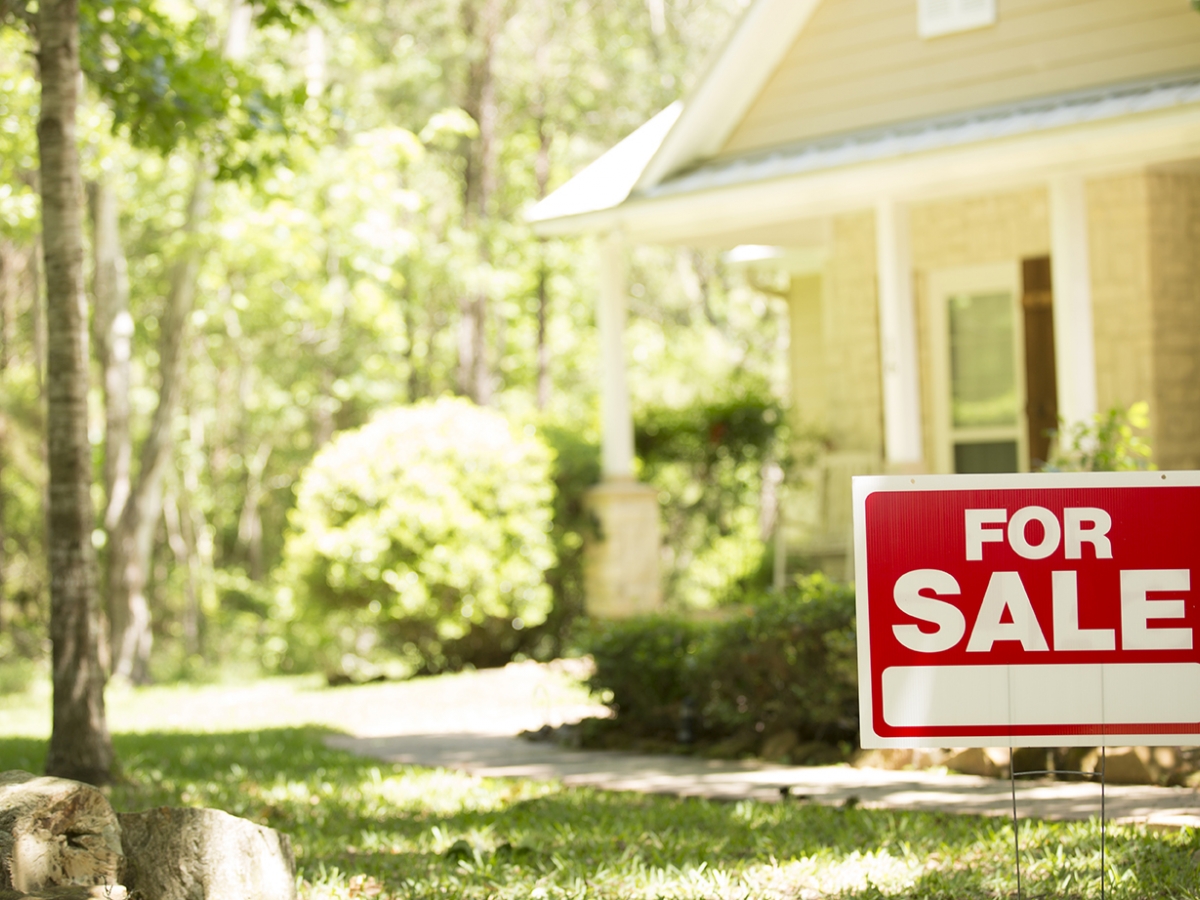 Moving House with a for sale sign out front